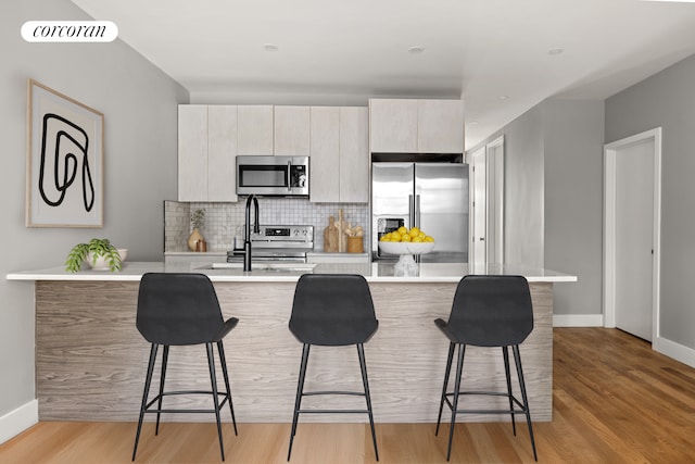 680-682 Hendrix St, New York City, NY 11207 - kitchen with stainless steel appliances, modern cabinets, light countertops, and a kitchen breakfast bar