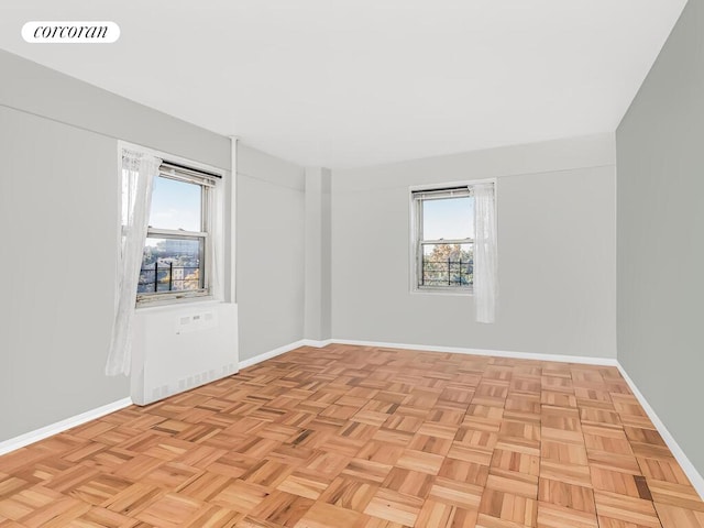 empty room with visible vents, baseboards, and a healthy amount of sunlight