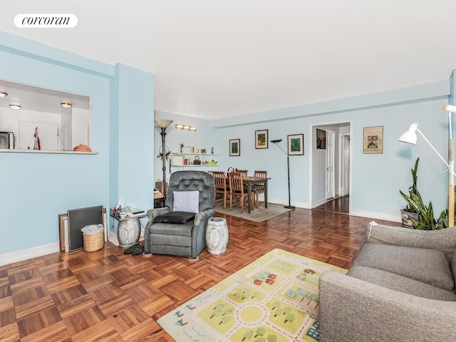 living area with visible vents and baseboards