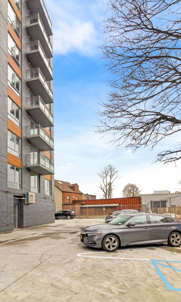 70-09 45th Ave Unit 6D, New York City, NY 11377 - view of apartment building / complex featuring uncovered parking