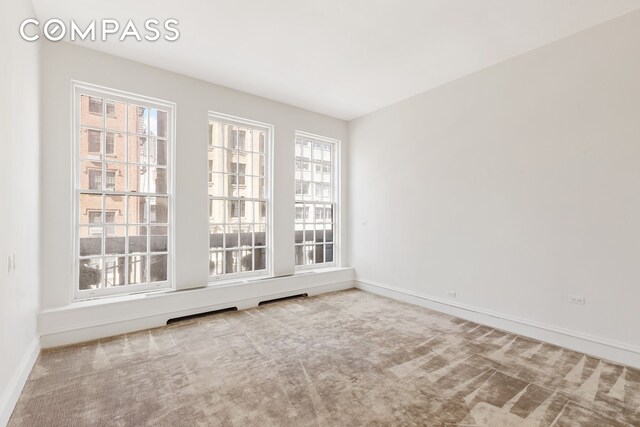 45 E 66th St Unit 4Nw, New York City, NY 10065 - unfurnished room featuring healthy amount of natural light, baseboards, and carpet floors