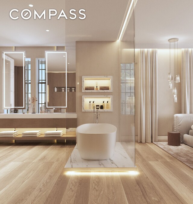 45 E 66th St Unit 4Nw, New York City, NY 10065 - bathroom with a freestanding bath, wood finished floors, and double vanity