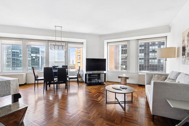 living room featuring crown molding and baseboards
