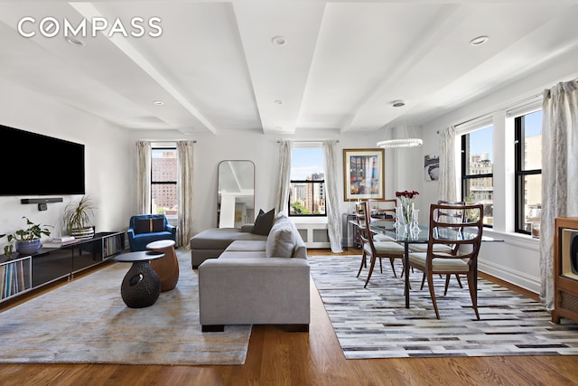 175 W 93rd St Unit 10C, New York City, NY 10025 - living area with plenty of natural light, beam ceiling, wood finished floors, and baseboards