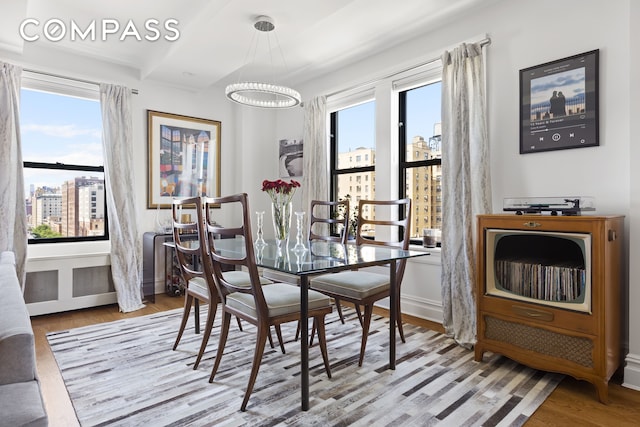 175 W 93rd St Unit 10C, New York City, NY 10025 - dining room with a chandelier, wood finished floors, and a view of city