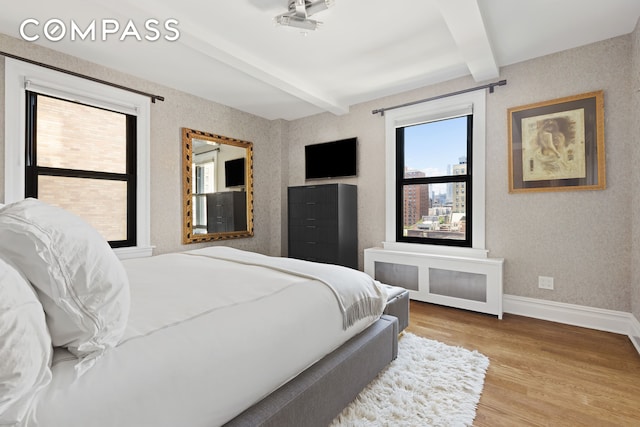175 W 93rd St Unit 10C, New York City, NY 10025 - bedroom with beamed ceiling, baseboards, wood finished floors, and radiator heating unit