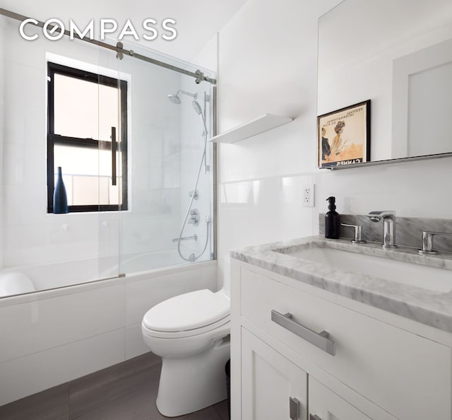 175 W 93rd St Unit 10C, New York City, NY 10025 - bathroom featuring combined bath / shower with glass door, toilet, and vanity