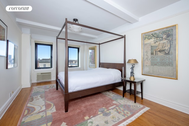 400 W End Ave Unit 13A, New York City, NY 10024 - bedroom featuring wood finished floors, beamed ceiling, and a wall mounted air conditioner