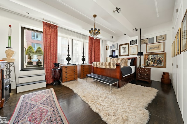 347 W 39th St Unit 8E, New York City, NY 10018 - bedroom with dark wood finished floors and a chandelier