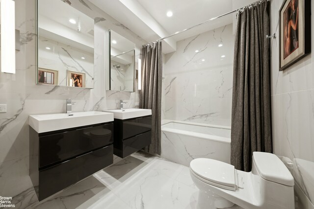 347 W 39th St Unit 8E, New York City, NY 10018 - full bathroom with stone wall, marble finish floor, and toilet
