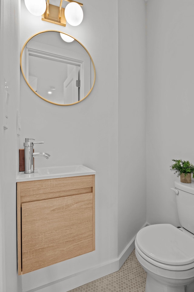 bathroom featuring toilet and vanity