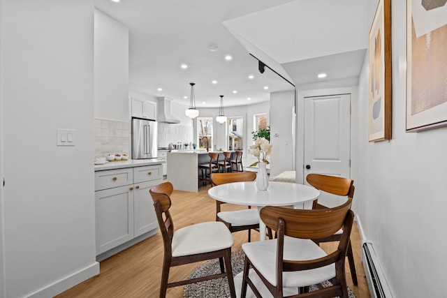 dining area with recessed lighting, light wood finished floors, and baseboards