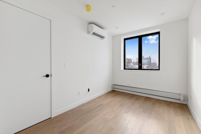unfurnished room featuring baseboards, a baseboard radiator, light wood-type flooring, and an AC wall unit