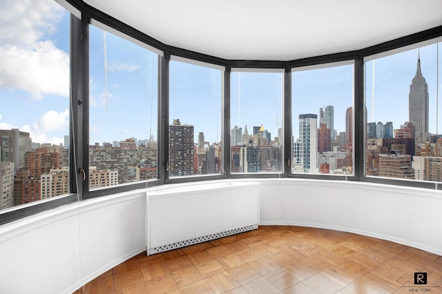 330 E 38th St Unit 26-A, New York City, NY 10016 - unfurnished sunroom with a skyline view and radiator heating unit