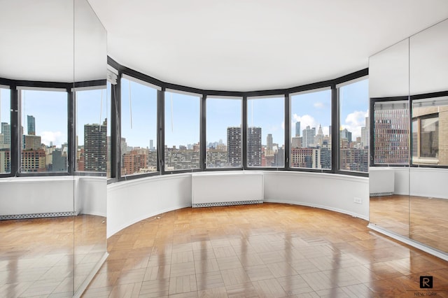 330 E 38th St Unit 26-A, New York City, NY 10016 - spare room featuring a skyline view and baseboards