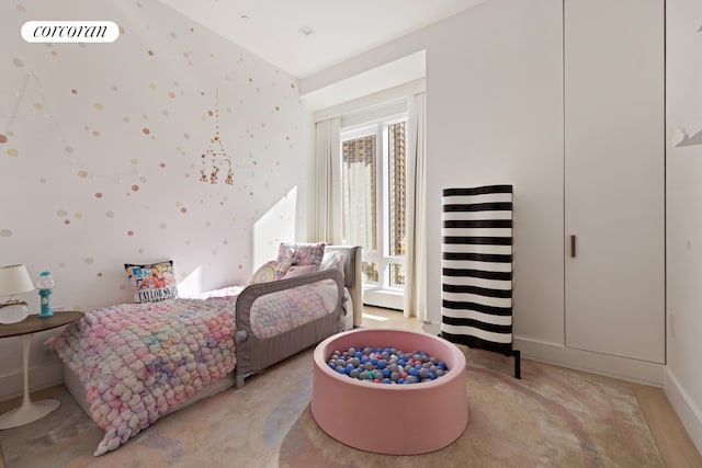 bedroom featuring light colored carpet