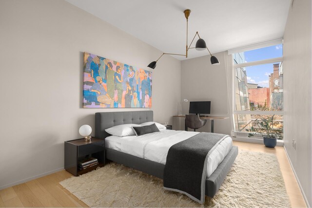 245 10th Ave Unit 3W, New York City, NY 10001 - bedroom featuring wood finished floors and baseboards