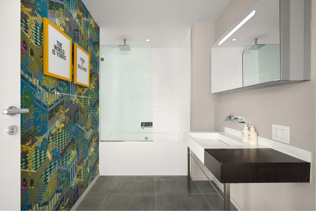 245 10th Ave Unit 3W, New York City, NY 10001 - full bath with tile patterned floors, vanity, and a combined bath / shower with rainfall shower