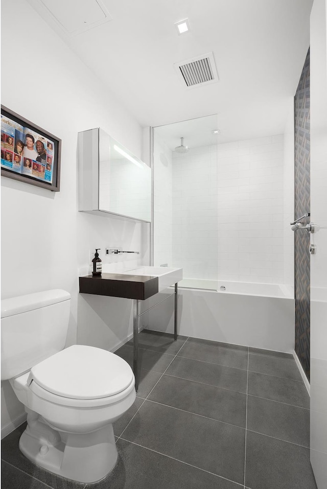 245 10th Ave Unit 3W, New York City, NY 10001 - full bath featuring toilet, a combined bath / shower with rainfall shower, tile patterned flooring, and baseboards