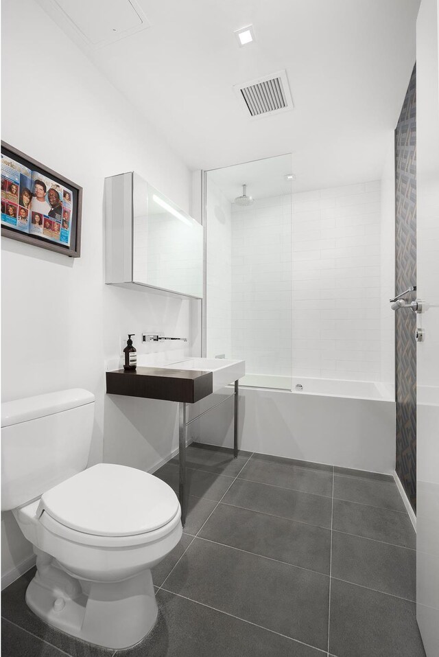245 10th Ave Unit 3W, New York City, NY 10001 - full bath featuring toilet, a combined bath / shower with rainfall shower, tile patterned flooring, and baseboards