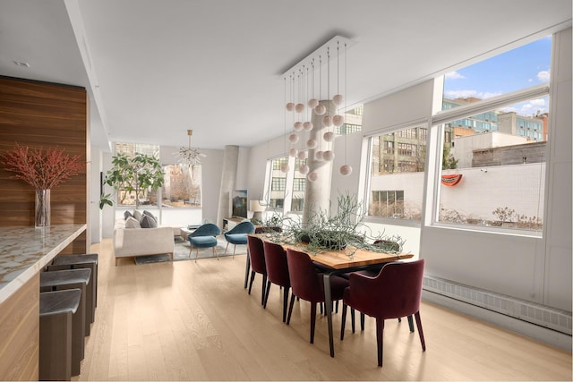 245 10th Ave Unit 3W, New York City, NY 10001 - dining area with light wood finished floors and a chandelier