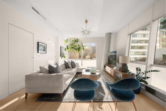 245 10th Ave Unit 3W, New York City, NY 10001 - living area with a chandelier and wood finished floors
