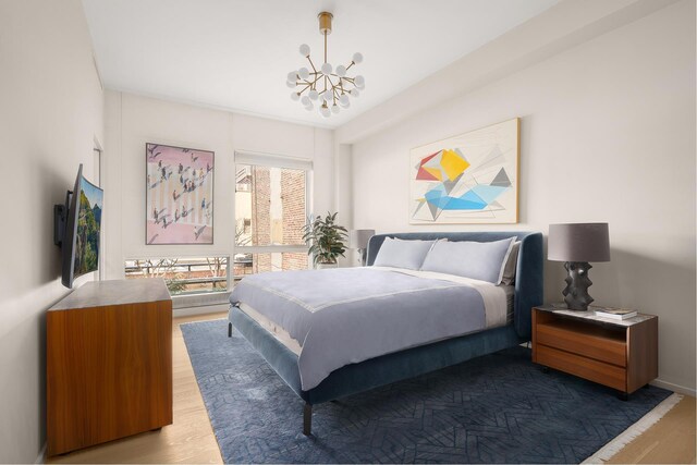 245 10th Ave Unit 3W, New York City, NY 10001 - bedroom with a chandelier and wood finished floors
