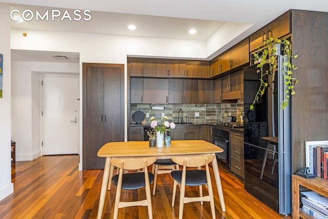 150 Myrtle Ave Unit 805, New York City, NY 11201 - kitchen with oven, tasteful backsplash, wood finished floors, dark countertops, and recessed lighting