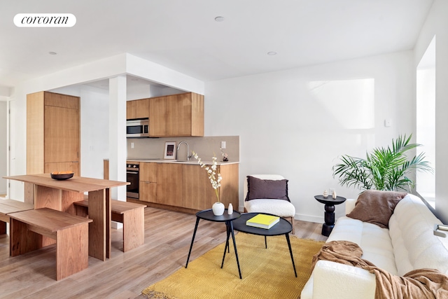 living room featuring light wood-style flooring and baseboards