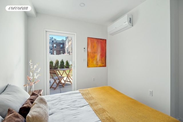 bedroom featuring a wall mounted AC and access to outside