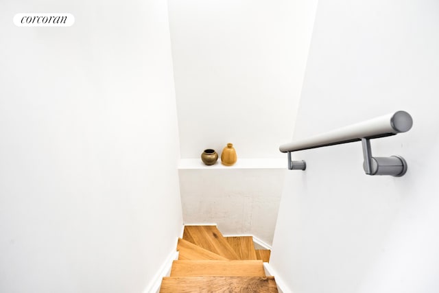 stairway with wood finished floors
