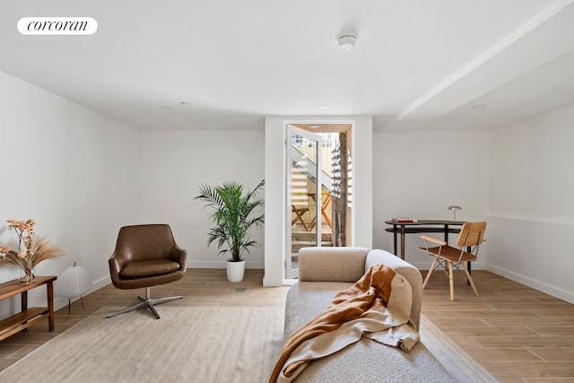 living area featuring wood finished floors and baseboards
