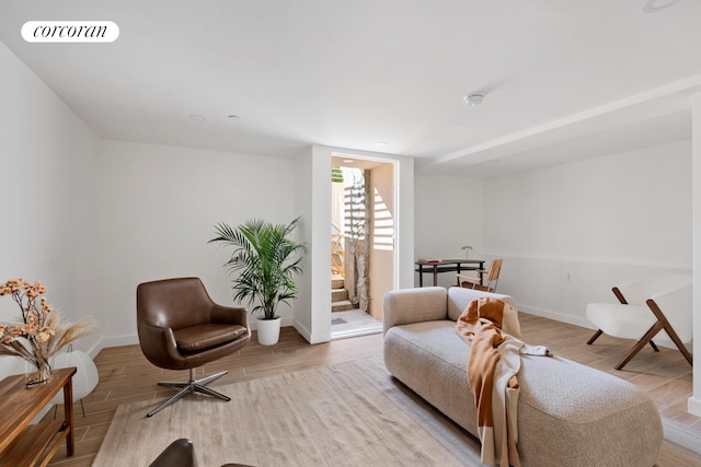 sitting room with wood finished floors and baseboards