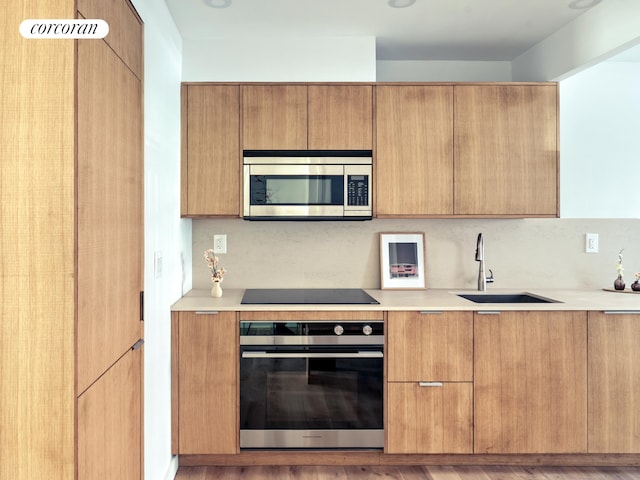 kitchen with appliances with stainless steel finishes and modern cabinets