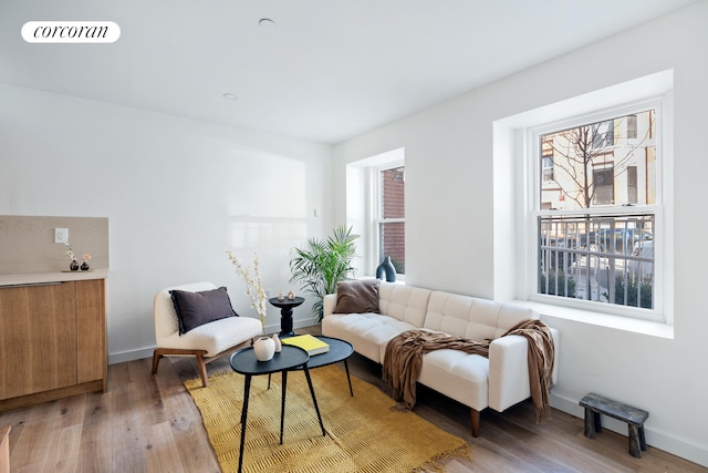 living area featuring light wood-type flooring and baseboards