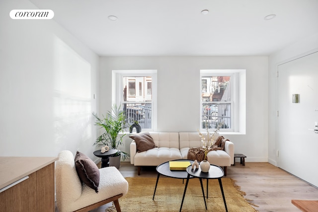 living room featuring plenty of natural light, light wood-style floors, recessed lighting, and baseboards