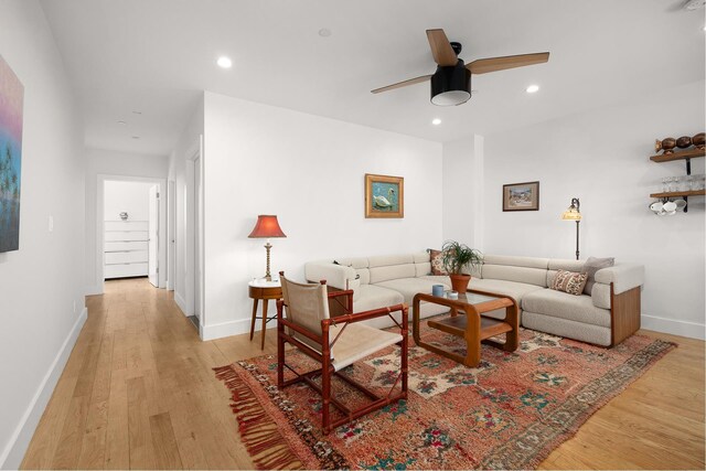 living area with a ceiling fan, baseboards, light wood finished floors, and recessed lighting
