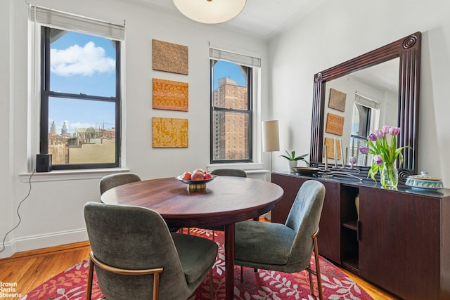 dining space with wood finished floors and baseboards