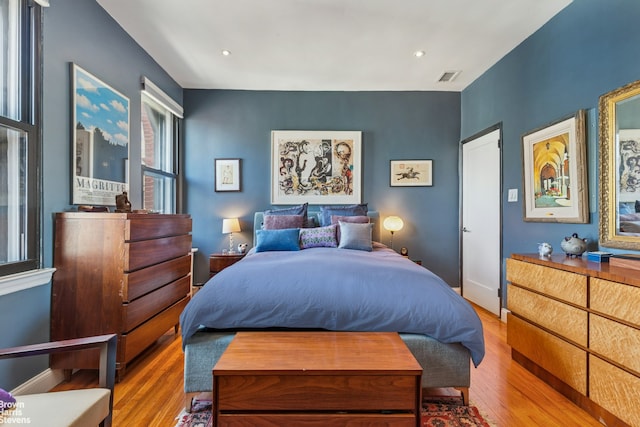 bedroom with wood finished floors and baseboards