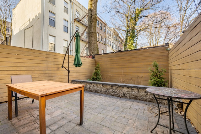 view of patio featuring outdoor dining space and a fenced backyard