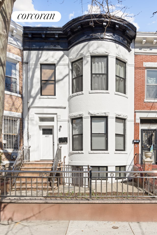 407 Lincoln Rd, New York City, NY 11225 - view of property with a fenced front yard and brick siding