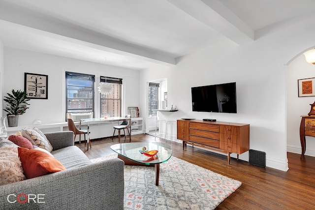 living area featuring beamed ceiling, arched walkways, baseboards, and dark wood-type flooring