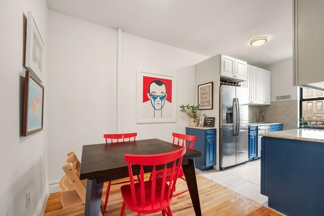 dining area with light wood-style flooring