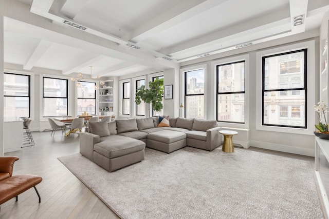 260 Park Ave S Unit 9Bc, New York City, NY 10003 - living area featuring wood finished floors, healthy amount of natural light, and beamed ceiling