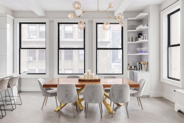 260 Park Ave S Unit 9Bc, New York City, NY 10003 - dining room featuring plenty of natural light, light wood-style flooring, and beamed ceiling