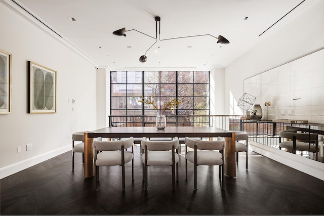 dining space with floor to ceiling windows and baseboards
