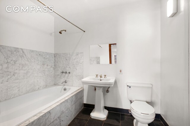 27 Bleecker St Unit 6B, New York City, NY 10012 - full bathroom featuring baseboards, toilet, and tile patterned flooring