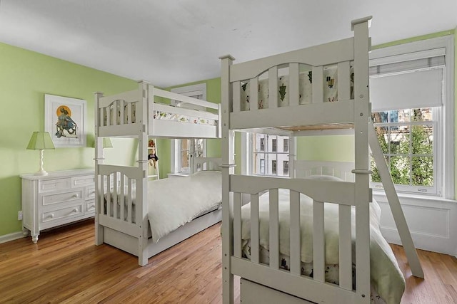 239 E 48th St, New York City, NY 10017 - bedroom featuring baseboards and wood finished floors