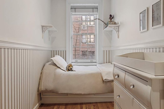 239 E 48th St, New York City, NY 10017 - bedroom with wainscoting and wood finished floors