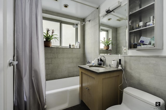 full bath with tile walls, vanity, toilet, visible vents, and shower / tub combo with curtain